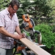Man using miter saw to cut fence panel