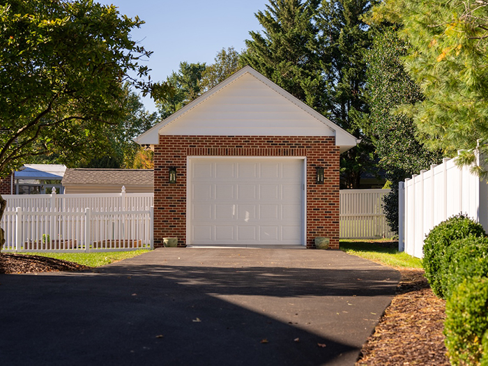 Garage with white picket fence