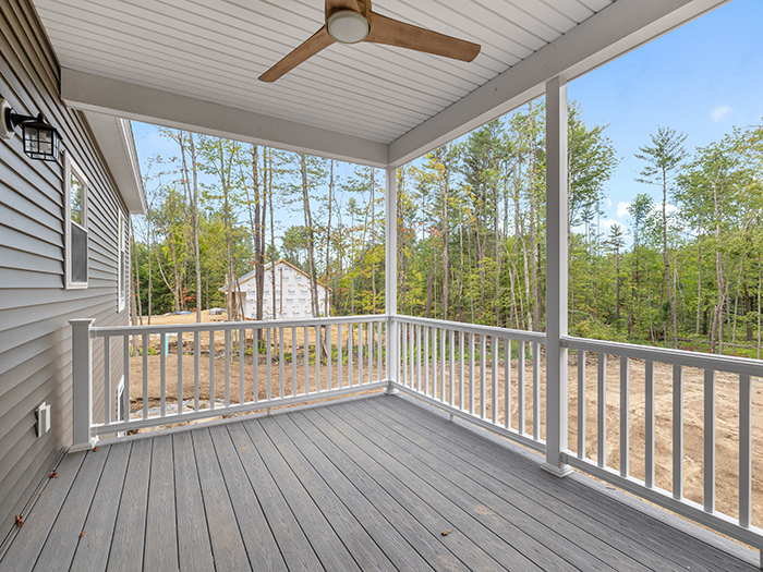 Screened porch on a new build home with composite decking and ceiling fan