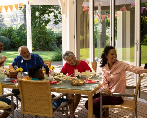 Family eating together at a table on a screened porch