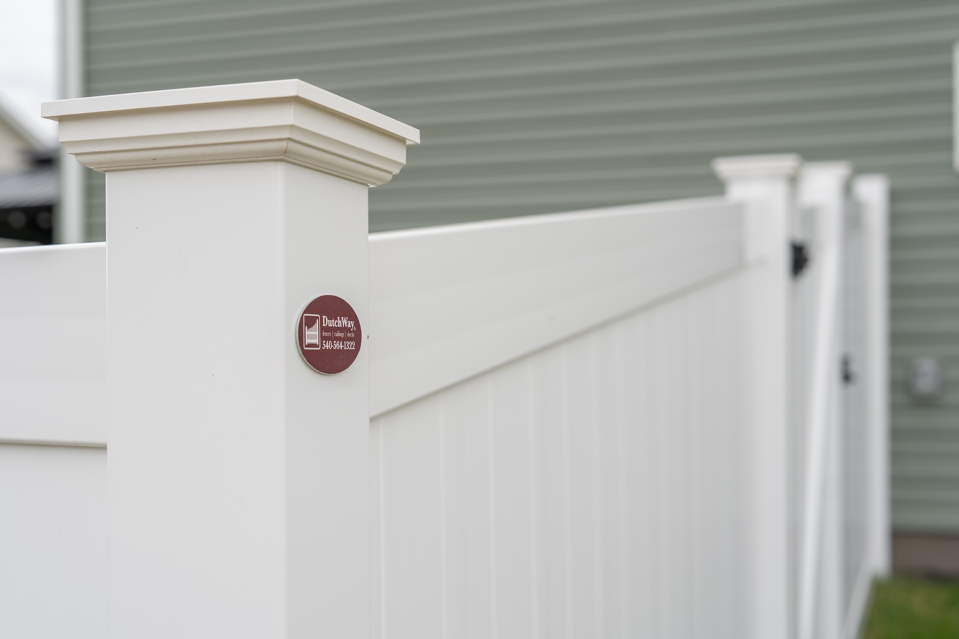 White vinyl privacy fence with Dutch Way logo