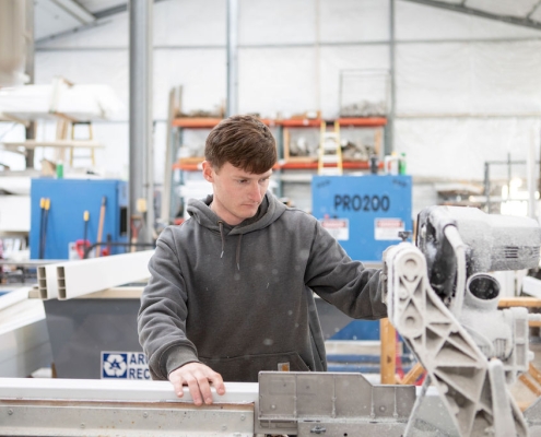 A local fence company worker creating and manufacturing a fence.