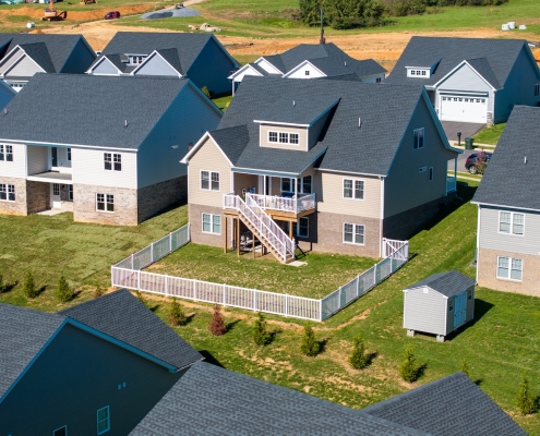 House with a vinyl fence in a subdivision.
